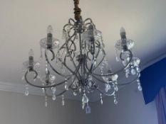 A contemporary cut glass and brushed metal eight branch pendant ceiling electrolier with cut glass