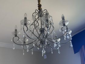 A contemporary cut glass and brushed metal eight branch pendant ceiling electrolier with cut glass