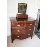 An early to mid 19th century mahogany bow fronted cross banded chest of two short over three long