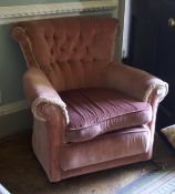 An early/mid-20th century style pink velvet upholstered button back armchair.
