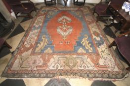 A hand made woollen Persian carpet.