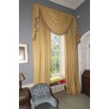 A pair of lined curtains with tassled pelmet.