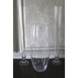 A collection of three tall glass lily vases. 80cm max H, to include one with a ground pontil scar.