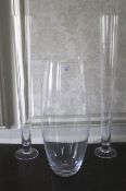 A collection of three tall glass lily vases. 80cm max H, to include one with a ground pontil scar.