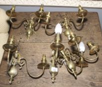 A set of five twin branched brass wall lamps.
