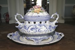 A Continental soft paste tureen and stand. Loop handles and hand painted blue decoration, 32cm H.