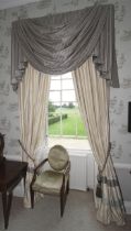 A pair of lined curtains with tassled pelmet.