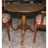 A Georgian oak tripod formerly tilt top circular table. 70cm H x 83cm diameter.