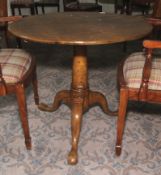 A Georgian oak tripod formerly tilt top circular table. 70cm H x 83cm diameter.