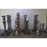 A collection of assorted silver plate candlesticks.