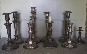 A collection of assorted silver plate candlesticks.