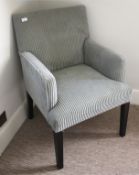 A 20th century Edwardian style upholstered armchair, 91cm H, 60cm W, 56cm D,