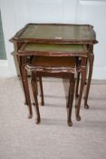 A 20th century nest of three leather topped tables, largest 56cm H, 56cm W,