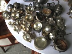 A large collection of silver plate comprising teapots, saucers, gravy boats, tea strainers, etc.
