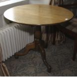 A Georgian oak tripod tilt top table. 71cm H x 87cm diameter.