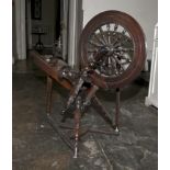 A 19th century stained pine wool spinning wheel, incomplete. 84cm H, 91cm W, 33cm D.