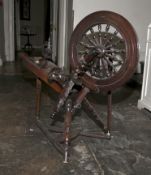 A 19th century stained pine wool spinning wheel, incomplete. 84cm H, 91cm W, 33cm D.