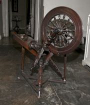 A 19th century stained pine wool spinning wheel, incomplete. 84cm H, 91cm W, 33cm D.