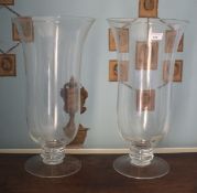 A pair of pedestal based glass storm lanterns. 50cm H.