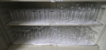 A large assortment of glassware. To include high balls, pint glasses, wine glasses etc.
