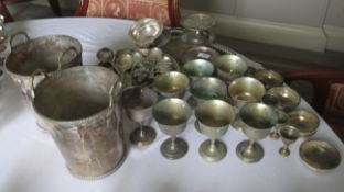 A collection of white metal goblets, silver plated spoons and a pair of silver plated wine coolers.