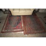 Two rugs to include a Persian red ground rug, 244cm x 144cm, with yellow, blue,