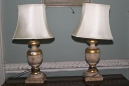 A pair of gilt and flecked turned table lamps. 75cm H, with shaped shades.