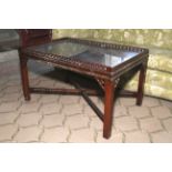 A Chippendale Revival pierced mahogany tray top coffee table.