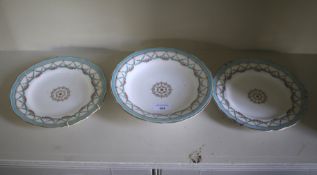 A Copeland fruit stand and two plates with floral and swag pattern on turquoise border.