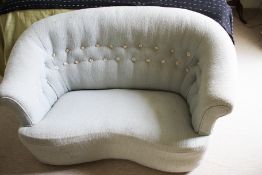 A 20th century scroll and shaped button back two seat sofa.