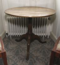 A Georgian oak tripod former tilt top pedestal table. 70cm H, 80cm diameter.