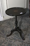A 20th century mahogany dish topped pedestal wine table. Tripod base. 50cm H and 35cm diameter.