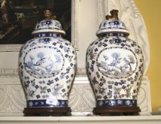 A pair of contemporary Chinese baluster shaped lidded vases and stands. 41cm H.