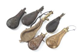 A collection of six black powder/shot flasks. Comprising three brass and three leather examples.
