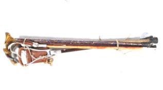 A collection of shooting accessories. Comprising two shooting sticks and three walking sticks.