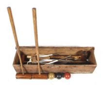 A boxed vintage croquet set. Comprising six metal hoops, three mallets and three balls, etc.