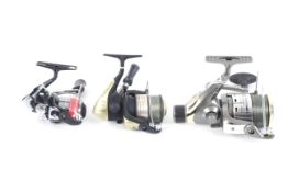 A collection of three fishing reels.