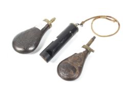A collection of sporting accessories. Comprising two powder flasks and a bird caller.