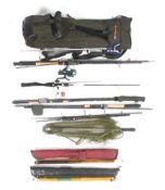 A collection of fishing rods and reels in rod bag.