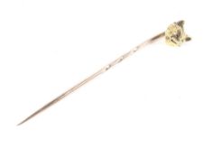 An early 20th century gold fox mask stickpin with rose diamond eyes.