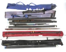 A collection of mixed fishing rods and a beach rod stand.