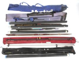 A collection of mixed fishing rods and a beach rod stand.