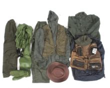 An assortment of fishing items to include waders, a wax hat, etc.