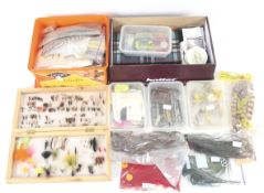 A collection of fly fishing equipment. Including a fly kit, feather, etc.