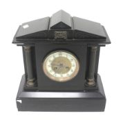 Black slate striking mantel clock. With architectural features, Arabic numerals.