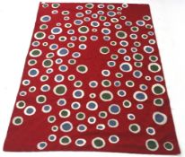 Zaida Kashmir wool textile throw red ground with circles.