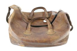 A large vintage brown leather bag.