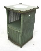A Lloyd loom Lusty bedside cabinet. Coloured green with gilt details and a glass top, H64cm x W40.
