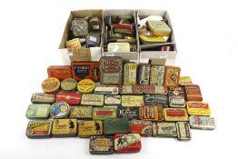A collection of assorted small vintage product advertising tins.