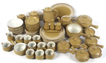 A collection of mid-century Denby pottery tableware. Including jugs, pots, dishes, etc. Max.